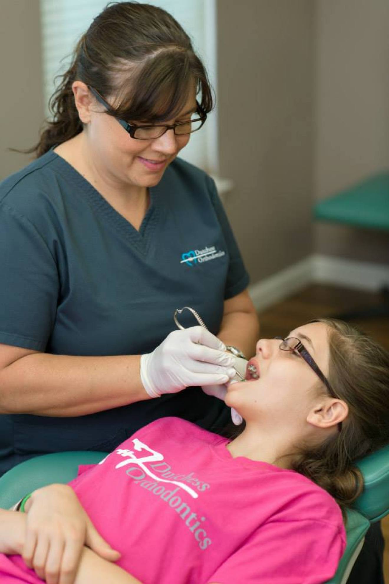 Team member examining patient's teeth